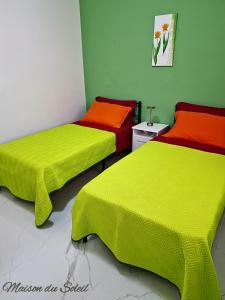 A bed or beds in a room at Maison du Soleil