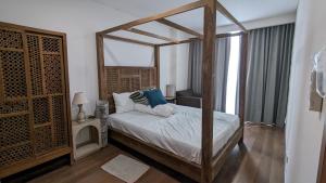 a bedroom with a canopy bed and a window at Vasaka The Reiz Condo in Medan +13 photos