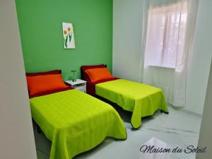 A bed or beds in a room at Maison du Soleil