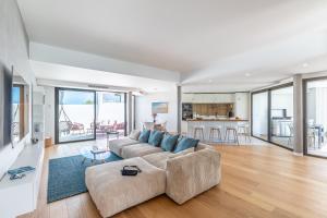 a large living room with a couch and a table at Villa Baroya - Villa piscine proche des plages in Bidart