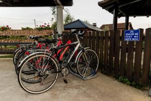 two bikes are parked next to a fence at Etno Camp Lucić in Odžak