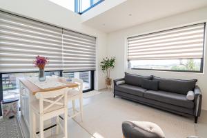 a living room with a couch and a table at Villa Amelia by Travel Pro - Mouries Halkidiki in Paralia Dionysiou
