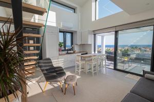 a kitchen and dining room with a view of the city at Villa Amelia by Travel Pro - Mouries Halkidiki in Paralia Dionysiou