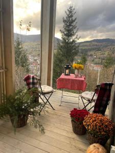 a porch with a table and chairs with a view at Miko II in Slavske