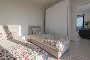 a bedroom with two beds and a mirror at Villa Amelia by Travel Pro - Mouries Halkidiki in Paralia Dionysiou +56 photos