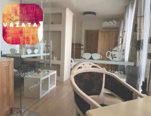 a room with a table and a chair in a room at V A z A T A apartment in Ruse