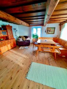 a living room with a table and a couch at Böhmerwald fun in Schwarzenberg am Bohmerwald