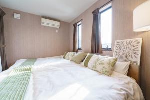 Postel nebo postele na pokoji v ubytování 豊橋民泊最大7名様駐車場1台無料 + 37 fotografií