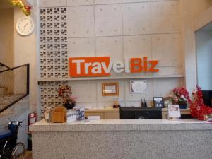 an office with a travel bus sign on the wall at Hotel Travel Biz in Medan