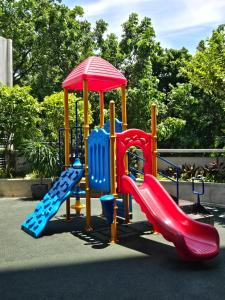 a playground with a slide and a slideintend at Stylish New Studio at McKinley Hill BGC Free Netflix in Manila