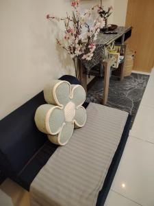 a couch with a pillow with a flower on it at Stylish New Studio at McKinley Hill BGC Free Netflix in Manila