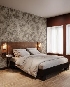 a bedroom with a large bed and a wall at Hota Hotel Porrentruy in Porrentruy +6 photos