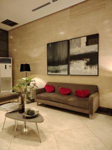 a living room with a couch and a table at Stylish New Studio at McKinley Hill BGC Free Netflix in Manila