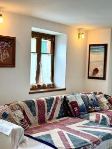a couch with a blanket on it in a room at Folghouse in Folgaria