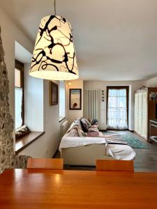 a bedroom with a bed and a chandelier at Folghouse in Folgaria