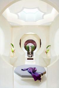 a room with a bed with a picture of a statue at Phulay Bay, A Ritz-Carlton Reserve in Tab Kaek Beach