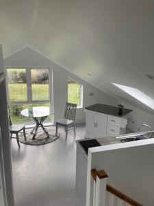 a kitchen and dining room with a table and chairs at Cillarney Lakeview Loft Apartment in Killarney