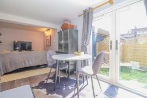 a room with a bed and a table and chairs at Gorgeous rural dog welcoming Milk Churn - Suffolk in Eye