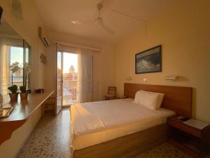 a bedroom with a bed and a large window at Florida Hotel & Apartments - Adults Only in Rhodes Town