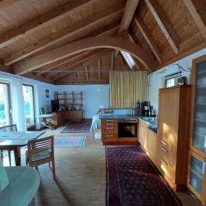 a kitchen with a table and a dining room at Das Wasserhaus - für Zwei in Gersdorf