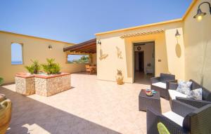a patio with chairs and tables in a house at Baglio Mediterraneo in Borgo Bonsignore