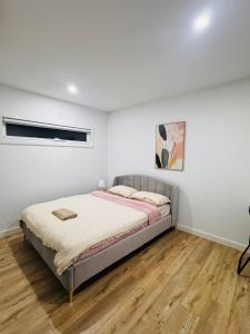 a bedroom with a bed in a white wall at Cozy room in Melbourne in Sunshine