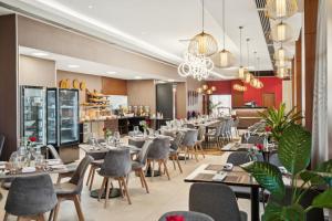 亚的斯亚贝巴Doubletree By Hilton Addis Ababa Airport的有桌椅的餐厅