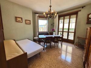 a bedroom with a bed and a dining room with a table at Chez Louise, free wi-fi & 5 minutes from InalpiArena in Turin