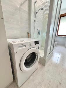 a washing machine in a bathroom with a shower at Chez Louise, free wi-fi & 5 minutes from InalpiArena in Turin