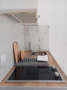 a small kitchen with a sink and a stove at LITO STUDIOS APARTMENTS in Pythagoreio