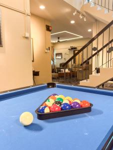 a pool table with a tray of balls on it at Lasam Heritage Villa 22pax with Karaoke & Snooker in Ipoh