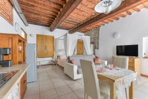 a kitchen and living room with a table and a dining room at Nido d'amore in Portoferraio
