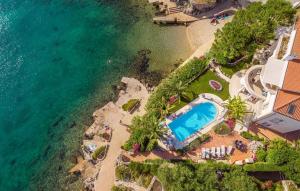 an aerial view of a resort with a swimming pool and the ocean at Villa Palace Clara Apartment 2 island Krk by Vill in Malinska
