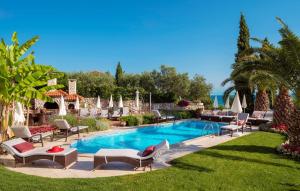 a swimming pool with lounge chairs and a resort at Villa Palace Clara Apartment 2 island Krk by Vill in Malinska