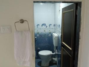 a bathroom with a toilet and a shower at Hotel Krushnai Athvan Farm House in Khamshet +6 photos