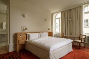 a hotel room with a bed and a table and chairs at Stockholm Stadshotell in Stockholm