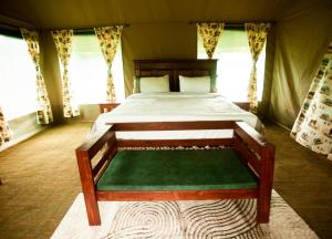 a bedroom with a bed in a tent at Maboresho Tented Camp in Serengeti National Park