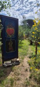 a box with a heart painted on it in a field at Glamping Castel Dell'Aquila in Gragnola