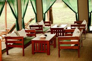a group of tables and chairs in a tent at Maboresho Tented Camp in Serengeti National Park