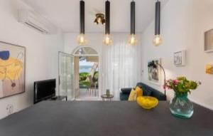 a living room with a table with a vase of flowers at Villa Palace Clara Apartment 6 island Krk by Villa in Malinska