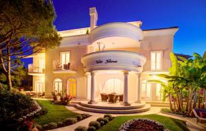 a large white house with a round driveway at Villa Palace Clara Apartment 5 island Krk by Vill in Malinska