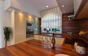 a kitchen with wine glasses on a wooden table at Villa Palace Clara Apartment 5 island Krk by Vill in Malinska
