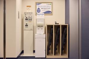 a room with a refrigerator and a shelf with baseball bats at Kobe Sannomiya Tokyu REI Hotel in Kobe +52 photos