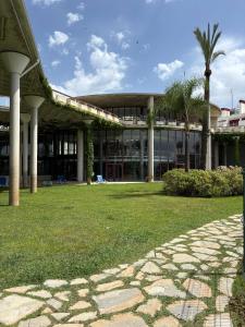 a building with a palm tree in front of it at Duplex Botánico Resort in Estepona