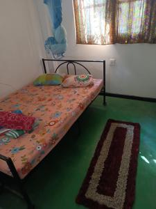 a bed in a room with a green floor at Local Life House in Dambulla