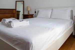 a white bed with towels on top of it at Welc-ōM Montegrotto Terrace View in Montegrotto Terme