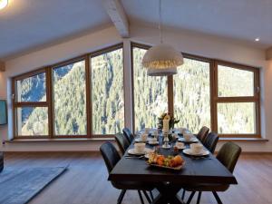 a dining room with a table and chairs and windows at Bergschnucke homes in See