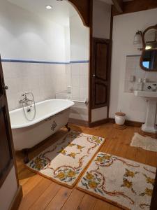 a bathroom with a tub and a sink at Le Bouffadou in Le Bouchet-Saint-Nicolas
