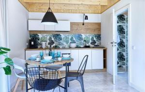 a dining room with a table and chairs in a kitchen at Beautiful Home In Bialogora With Wifi in Białogóra