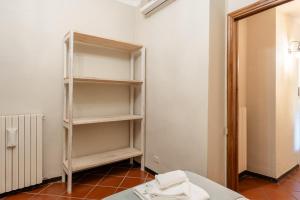 a room with a book shelf in a room at I Fossi Apartment - Lucca in Lucca +13 photos